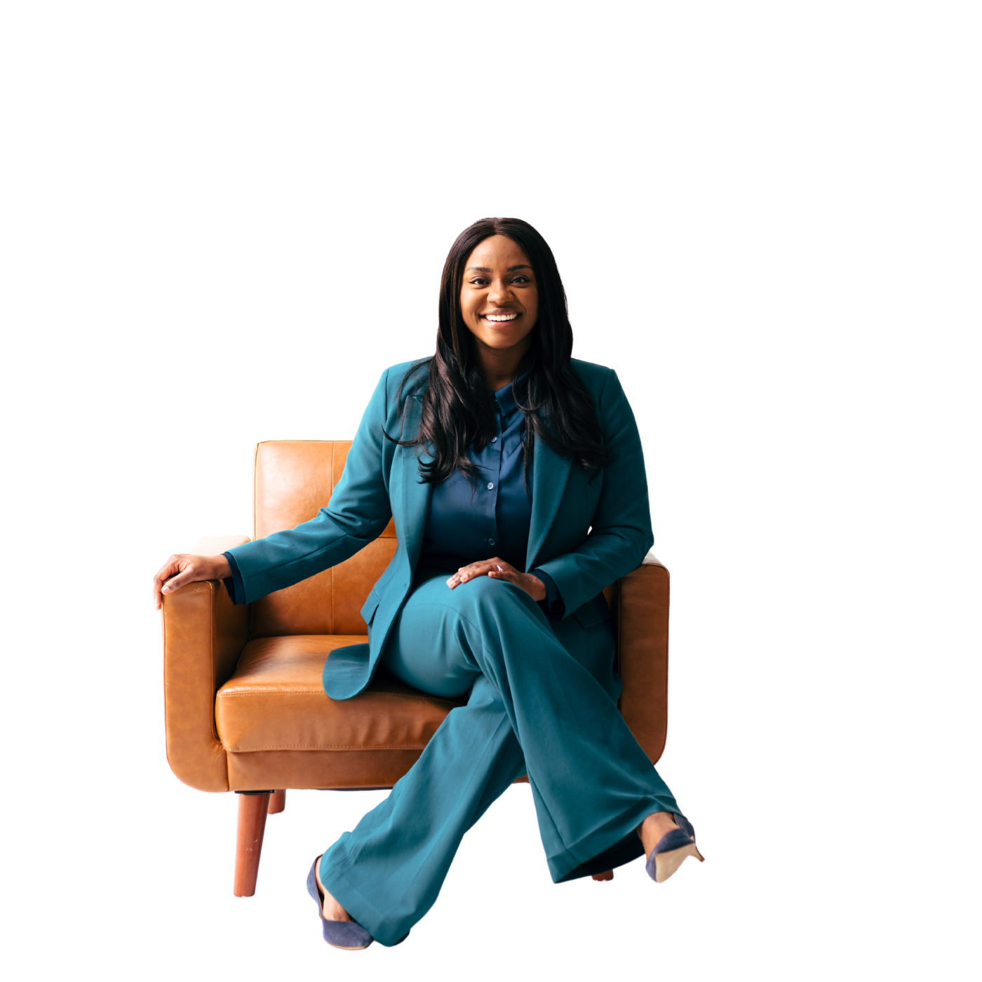 Danielle Bayard Jackson in a teal suit, seated in a leather armchair